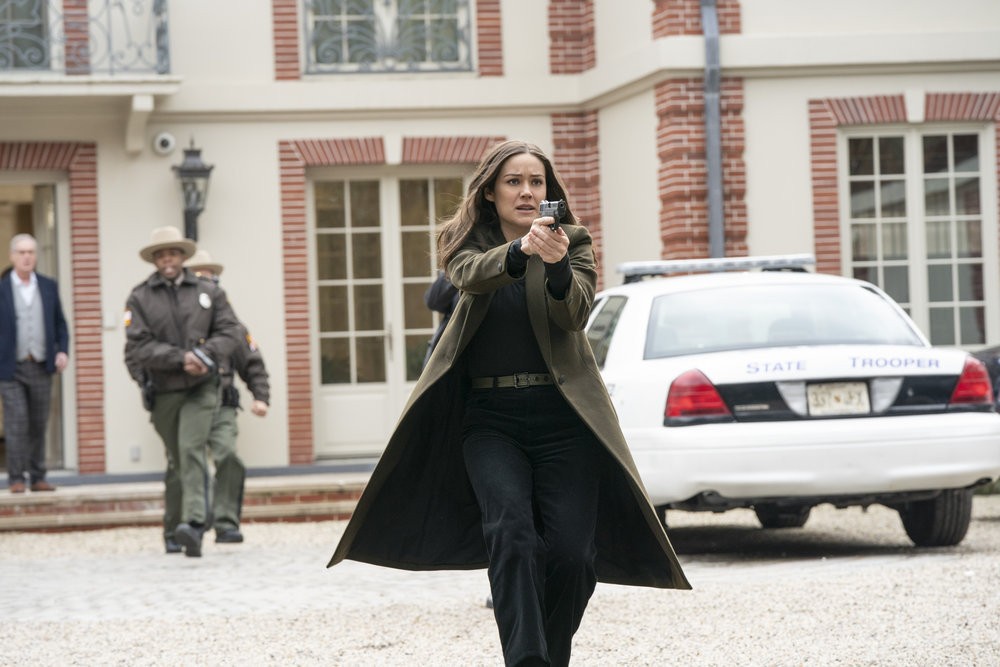 L'agent Keen (Megan Boone) menace quelqu'un de son arme de service