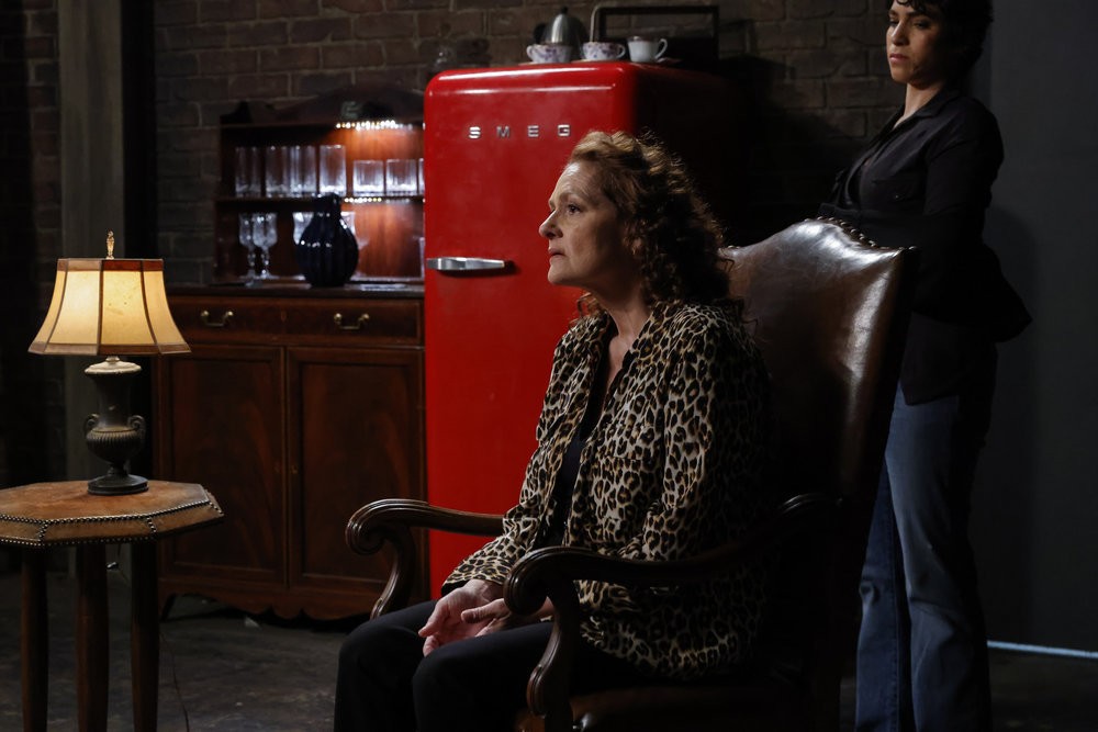 Heddie Hawkins (Aida Turturro) assise dans la planque de Reddington, alors que Weecha (Diany Rodriguez) assiste à sa conversation avec Red